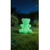 Figura de oso de cemento blanco con efecto fosforescente verde en la oscuridad