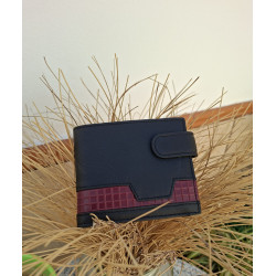 Cartera artesanal hecha en Ubrique con piel de máxima calidad, diseño lisviv, parte trasera sobre jarrón de esparto