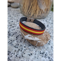 Lateral de pulsera de piel negra con cinta bandera de España.