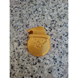 Detalle en primer plano de los relieves de la barba y el rostro de Papá Noel en la figura de cemento color oro.