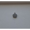 Adorno de cupcake de cemento pintado a mano con relieve estriado colgado en una pared texturizada blanca de día.